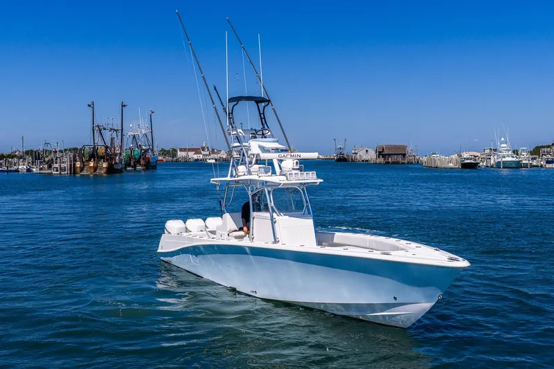 Fear N Money Yacht Photos Pics 2019 Concept 392 ProFish boat on water, with fishing rods and clear blue sky.