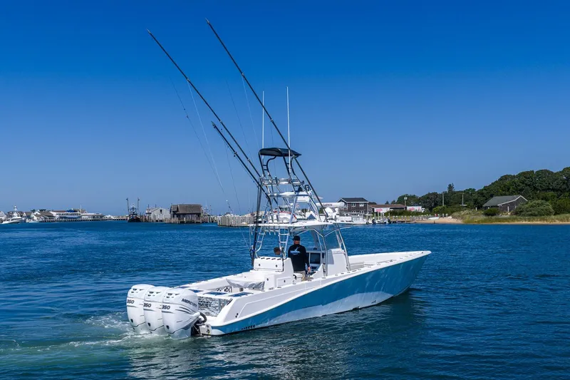 Fear N Money Yacht Photos Pics 2019 Concept 392 ProFish boat cruising in clear blue waters near a coastal town.