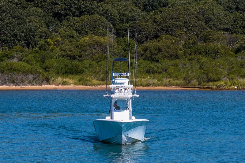 Fear N Money Yacht Photos Pics 2019 Concept 392 ProFish boat cruising on a serene lake with lush green backdrop.