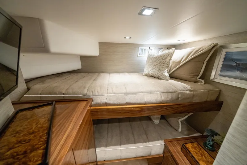 2026 Viking 90sb Yacht Photos Pics Luxurious cabin interior of 2026 Viking 90 Sky Bridge yacht with cozy bedding.