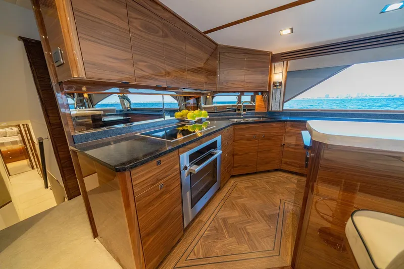 2026 Viking 90sb Yacht Photos Pics Luxurious kitchen interior of 2026 Viking 90 Sky Bridge yacht with ocean view.