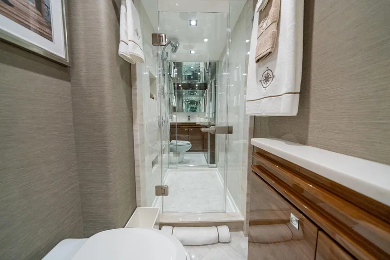 2026 Viking 90sb Yacht Photos Pics Luxurious bathroom in 2026 Viking 90 Sky Bridge yacht with modern shower and elegant decor.