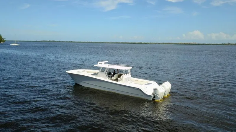  Yacht Photos Pics 2021 Invincible 46 Catamaran on calm waters under a clear blue sky.