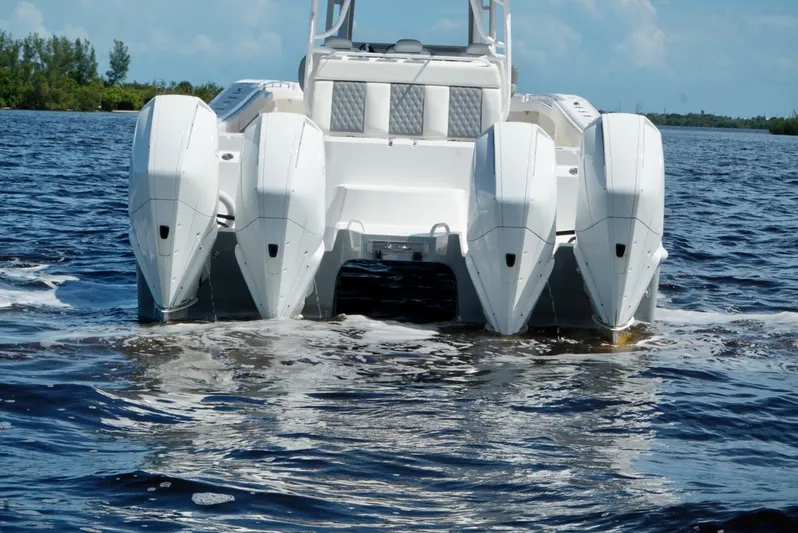  Yacht Photos Pics 2021 Invincible 46 Catamaran with quad outboard engines on the water.