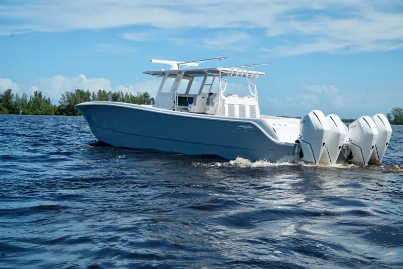 Yacht Photos Pics 2021 Invincible 46 Catamaran on open water with triple outboard engines.