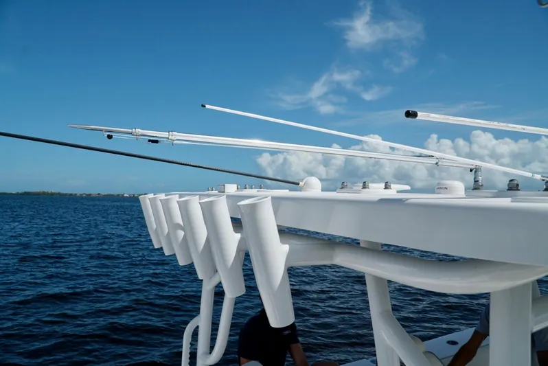  Yacht Photos Pics 2021 Invincible 46 Catamaran fishing rod holders on a sunny day at sea.