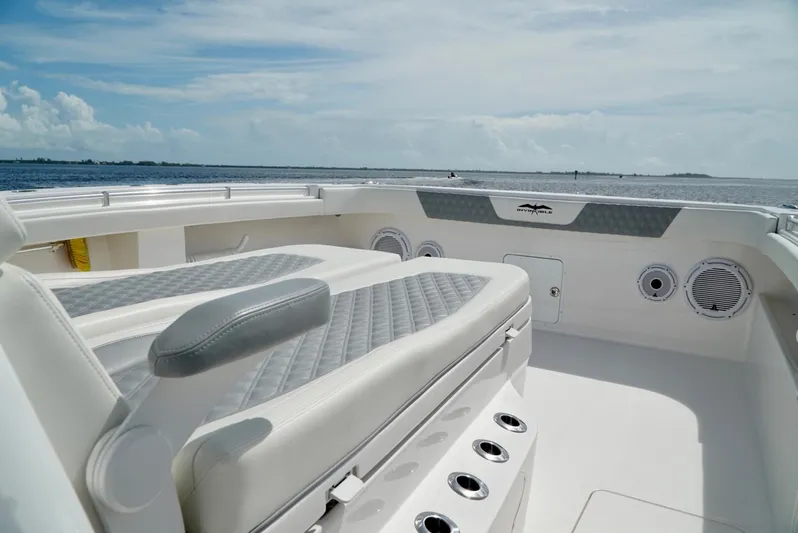  Yacht Photos Pics 2021 Invincible 46 Catamaran boat interior with cushioned seating and ocean view.