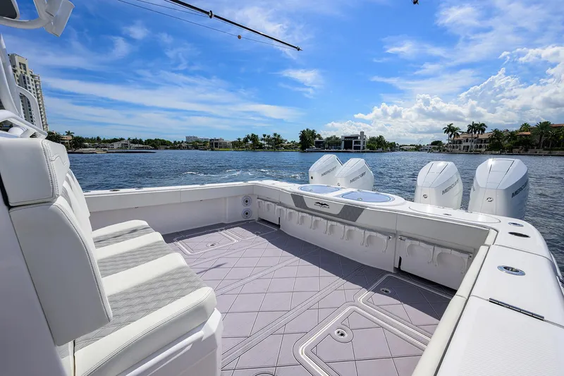 Argento II Yacht Photos Pics 2023 Invincible 46 Catamaran deck with seating, overlooking a scenic waterfront view.