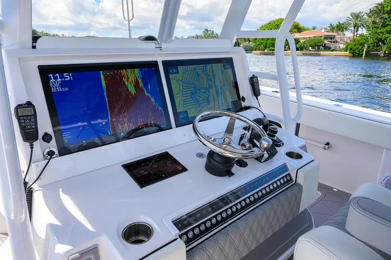Argento II Yacht Photos Pics 2023 Invincible 46 Catamaran helm with dual navigation screens and steering wheel.