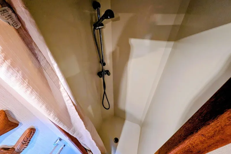 Innovation Yacht Photos Pics Shower area in 1978 Tollycraft 54 Custom Cockpit Motor Yacht, featuring a handheld showerhead.