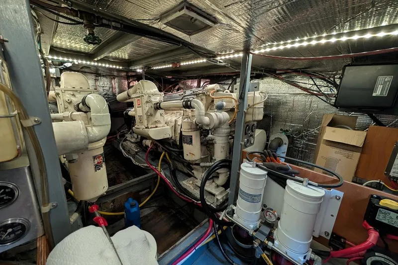 Innovation Yacht Photos Pics Engine room of a 1978 Tollycraft 54 Custom Cockpit Motor Yacht, featuring dual engines.