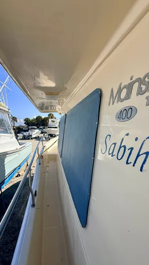 Sabiha Yacht Photos Pics Side view of 2004 Mainship 400 Trawler in harbor.