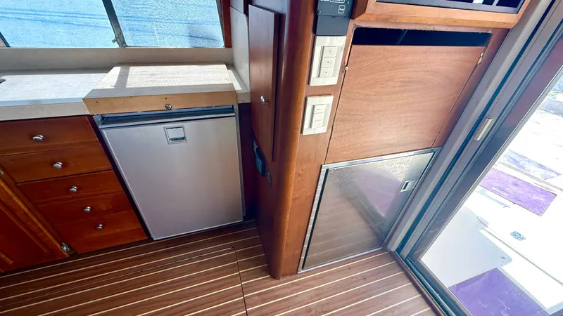 Sabiha Yacht Photos Pics Interior of 2004 Mainship 400 Trawler with wood flooring and refrigerator.