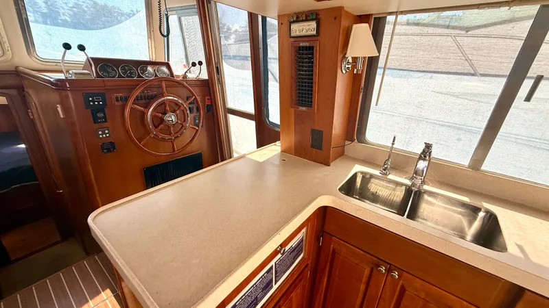 Sabiha Yacht Photos Pics Interior of 2004 Mainship 400 Trawler with helm and kitchen.