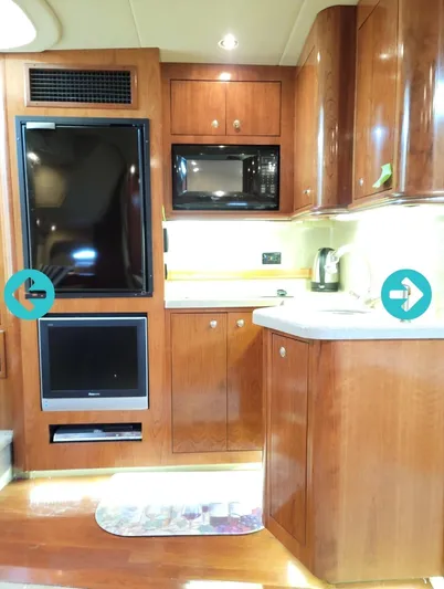  Yacht Photos Pics Interior of 2005 Cruisers Yachts 370 with wooden cabinetry and modern appliances.