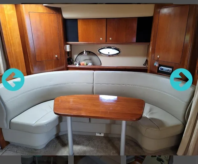  Yacht Photos Pics 2005 Cruisers Yachts 370 interior with curved seating and wooden table.