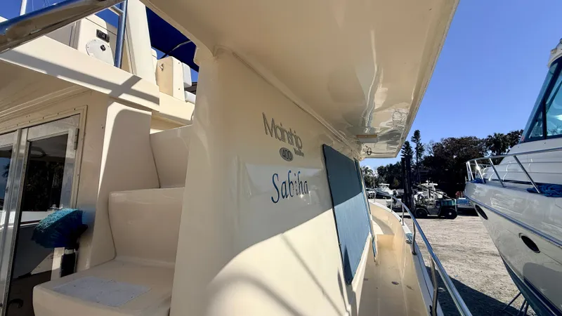 Sabiha Yacht Photos Pics 2004 Mainship 400 Trawler docked, side view.