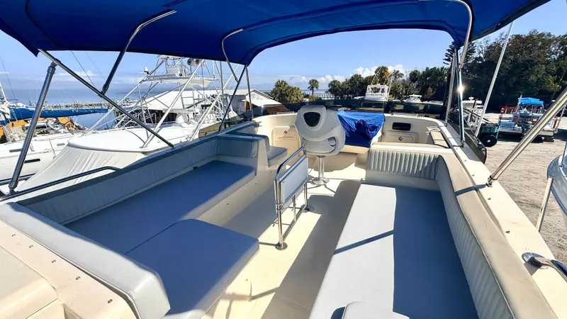 Sabiha Yacht Photos Pics 2004 Mainship 400 Trawler with blue sunshade at the harbor.