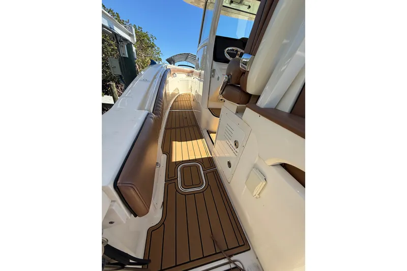 New Trade-in- All Offers & Trades Welcome Yacht Photos Pics 2018 Scout 350 LXF boat interior with teak flooring and cushioned seating.
