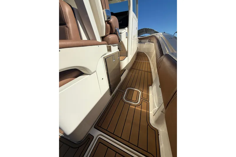 New Trade-in- All Offers & Trades Welcome Yacht Photos Pics 2018 Scout 350 LXF boat interior with teak flooring and leather seating.