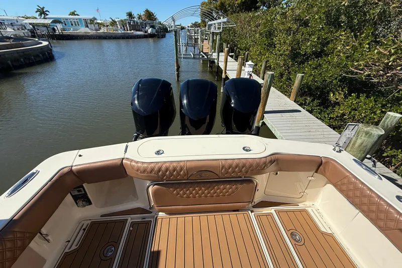 New Trade-in- All Offers & Trades Welcome Yacht Photos Pics 2018 Scout 350 LXF boat with triple engines docked by a wooden pier.