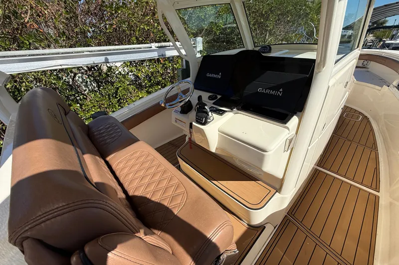 New Trade-in- All Offers & Trades Welcome Yacht Photos Pics 2018 Scout 350 LXF boat interior with Garmin navigation system and luxurious seating.