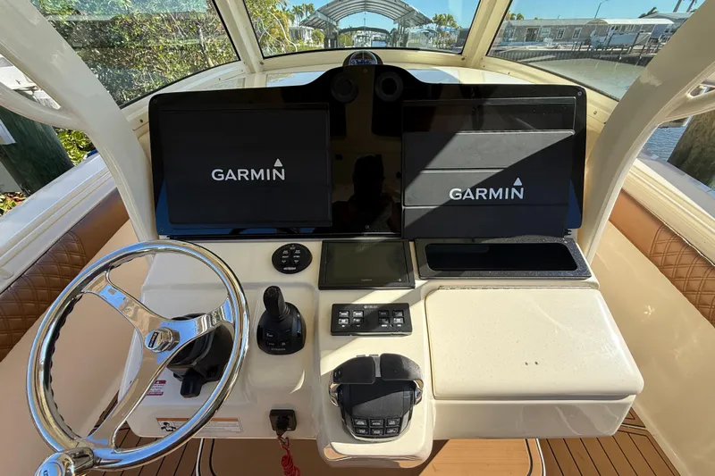 New Trade-in- All Offers & Trades Welcome Yacht Photos Pics 2018 Scout 350 LXF boat dashboard with Garmin navigation displays and steering wheel.