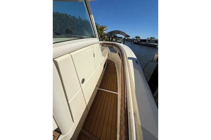 New Trade-in- All Offers & Trades Welcome Yacht Photos Pics 2018 Scout 350 LXF boat deck with sleek design and wooden flooring.