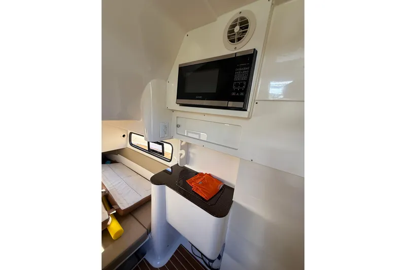 New Trade-in- All Offers & Trades Welcome Yacht Photos Pics 2018 Scout 350 LXF cabin interior with microwave and seating area.