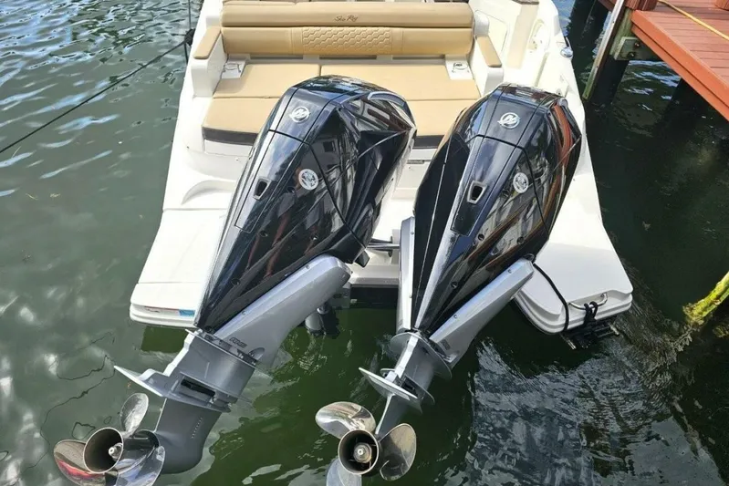Frisky Yacht Photos Pics 2018 Sea Ray SDX 290 Outboard with dual engines, docked on calm water.