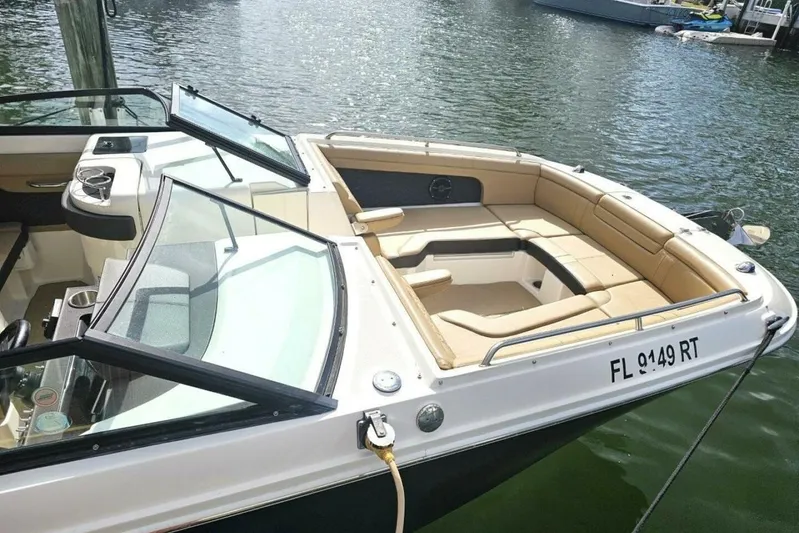 Frisky Yacht Photos Pics 2018 Sea Ray SDX 290 Outboard boat with tan seating, docked on calm water.
