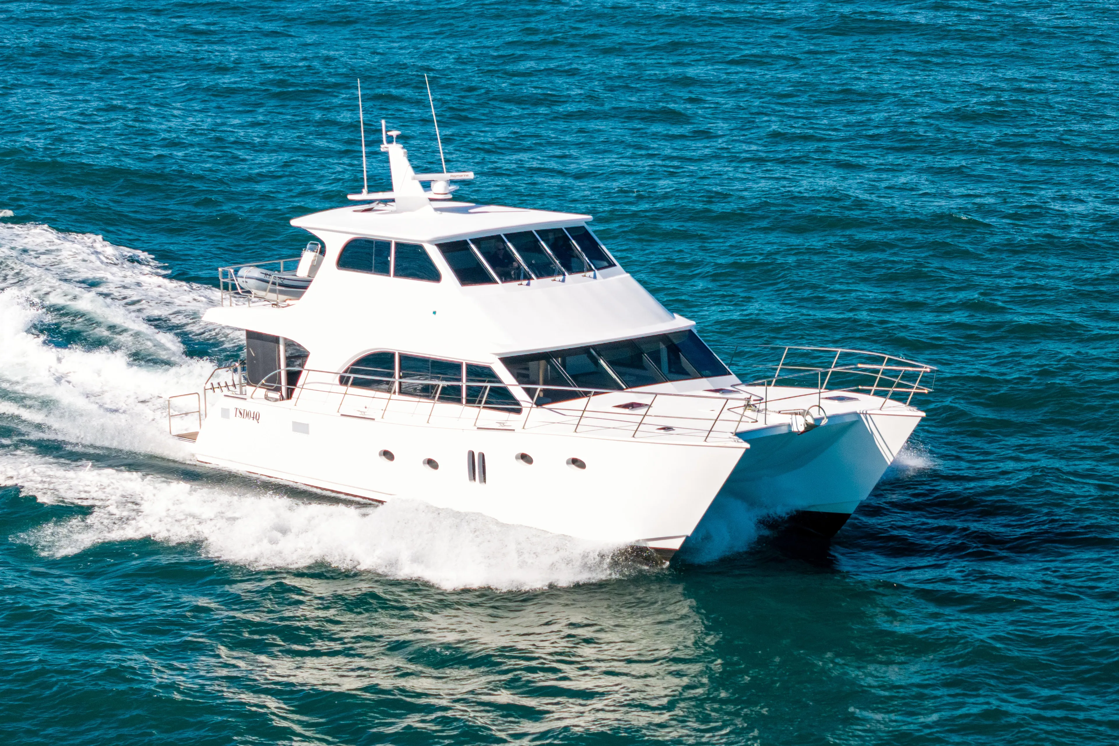 One Off Yacht Photos Pics 2019 Coral Coast 62 Power Catamaran cruising on open blue sea.