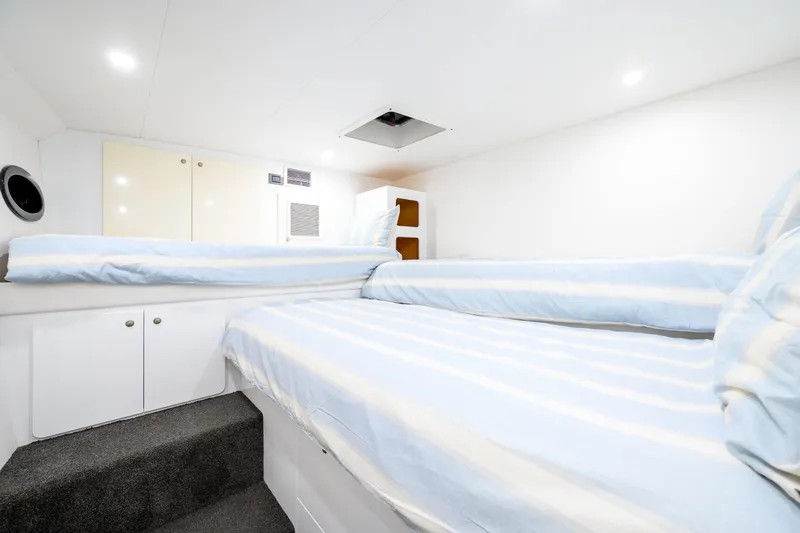 One Off Yacht Photos Pics Interior cabin of 2019 Coral Coast 62 Power Catamaran with twin beds and storage.
