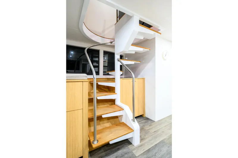 One Off Yacht Photos Pics Modern staircase on 2019 Coral Coast 62 Power Catamaran, featuring sleek design and wooden steps.