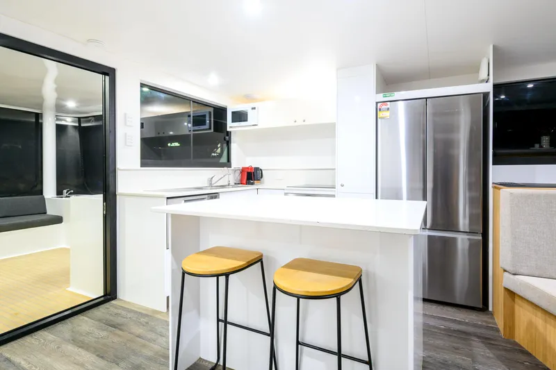 One Off Yacht Photos Pics Modern kitchen interior of 2019 Coral Coast 62 Power Catamaran with sleek design and appliances.