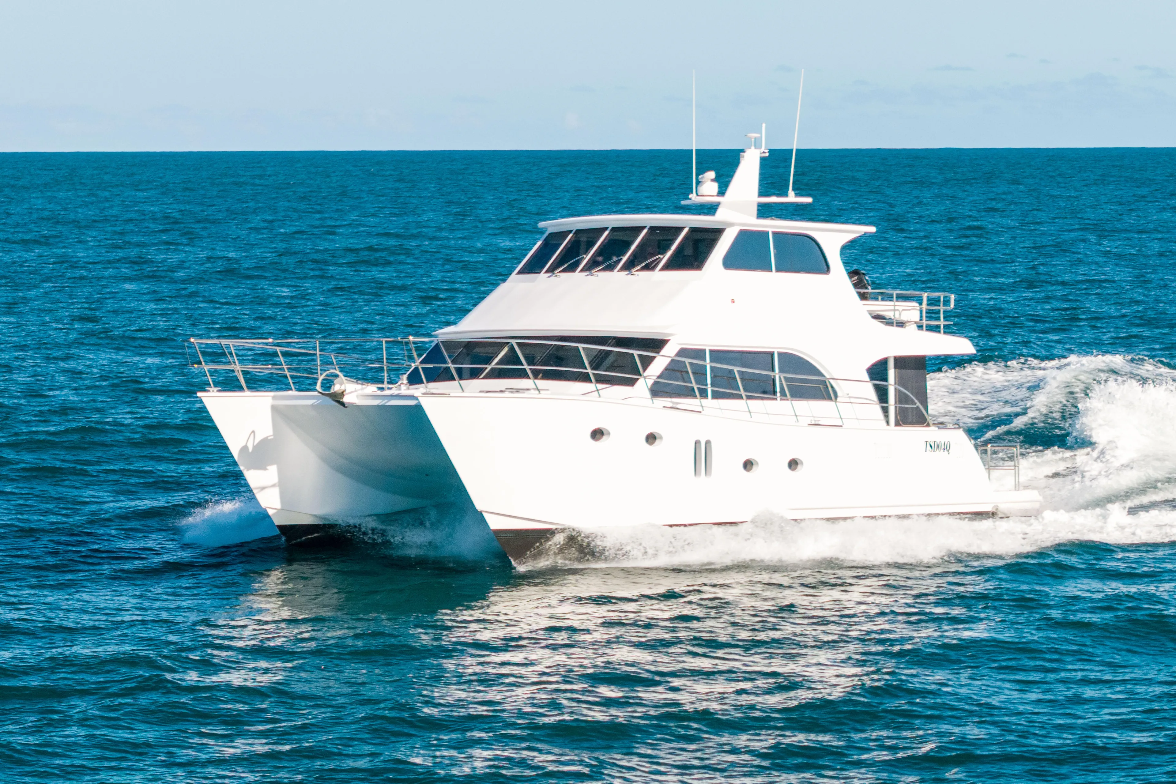 One Off Yacht Photos Pics 2019 Coral Coast 62 Power Catamaran cruising on open sea.
