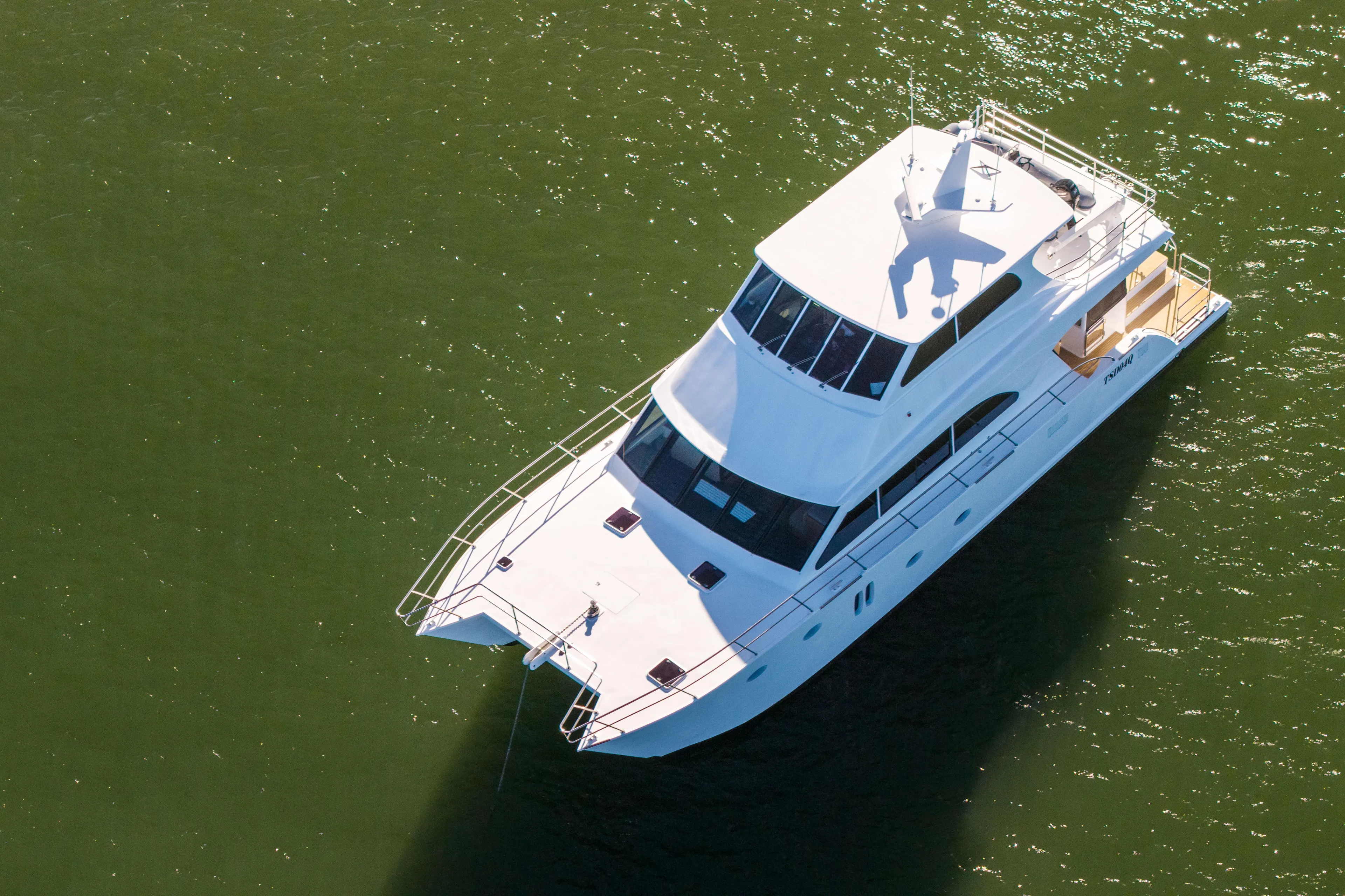 One Off Yacht Photos Pics Aerial view of 2019 Coral Coast 62 Power Catamaran on green water.