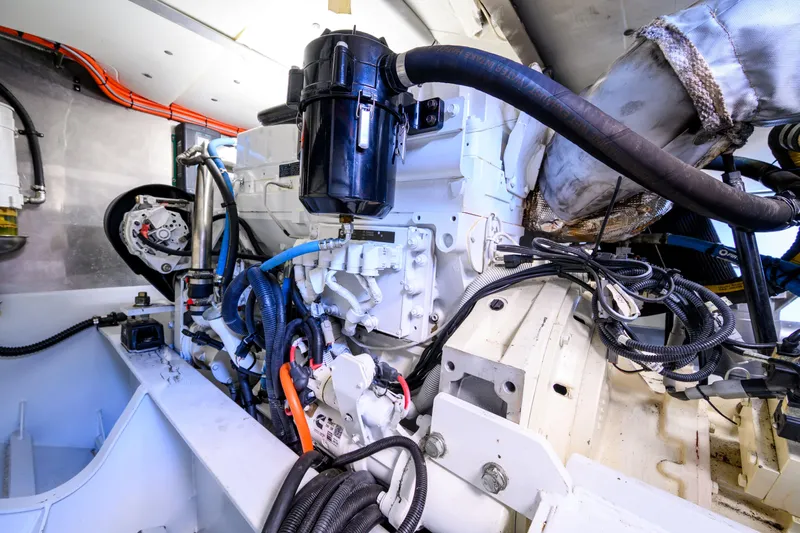 One Off Yacht Photos Pics Engine room of 2019 Coral Coast 62 Power Catamaran, showcasing complex machinery and wiring.