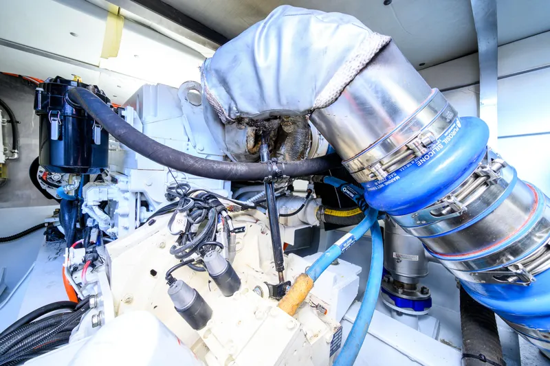 One Off Yacht Photos Pics Engine room of 2019 Coral Coast 62 Power Catamaran, showcasing mechanical components and piping.