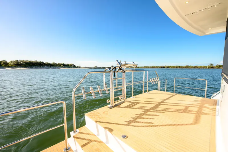 One Off Yacht Photos Pics Coral Coast 62 Power Catamaran 2019, spacious deck overlooking serene waters and clear blue sky.