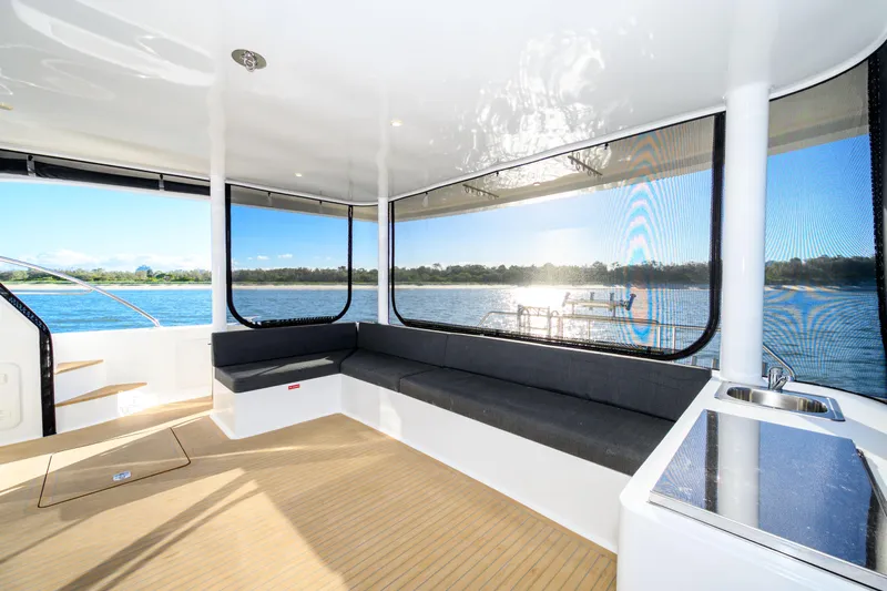 One Off Yacht Photos Pics Spacious interior of 2019 Coral Coast 62 Power Catamaran with panoramic water views.