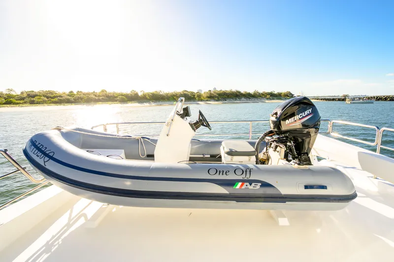 One Off Yacht Photos Pics Inflatable boat with Mercury engine on Coral Coast 62 Power Catamaran, 2019 model, in sunny waters.