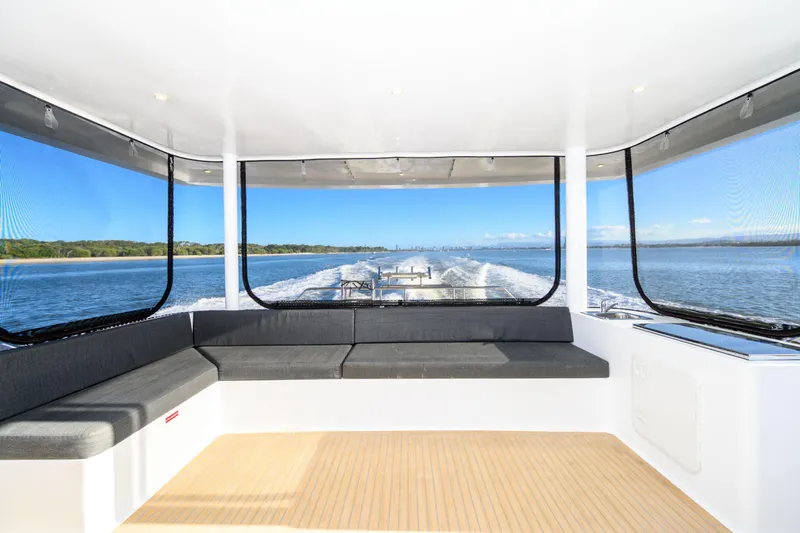 One Off Yacht Photos Pics Interior view of 2019 Coral Coast 62 Power Catamaran with panoramic windows and seating.