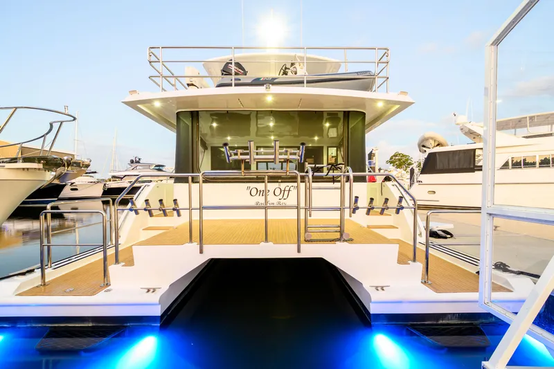 One Off Yacht Photos Pics 2019 Coral Coast 62 Power Catamaran docked with illuminated blue underwater lights.