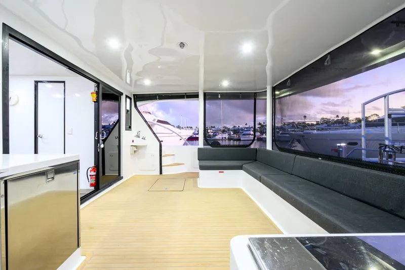 One Off Yacht Photos Pics Spacious interior of 2019 Coral Coast 62 Power Catamaran with modern seating and large windows.