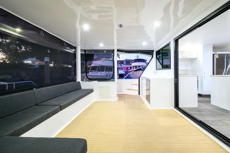 One Off Yacht Photos Pics Luxurious interior of 2019 Coral Coast 62 Power Catamaran with modern seating and kitchen area.