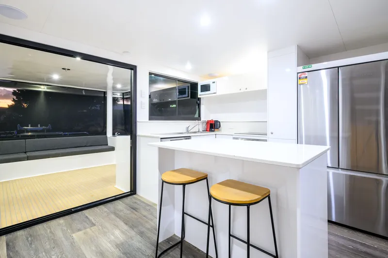 One Off Yacht Photos Pics Modern kitchen interior of 2019 Coral Coast 62 Power Catamaran with sleek design and appliances.