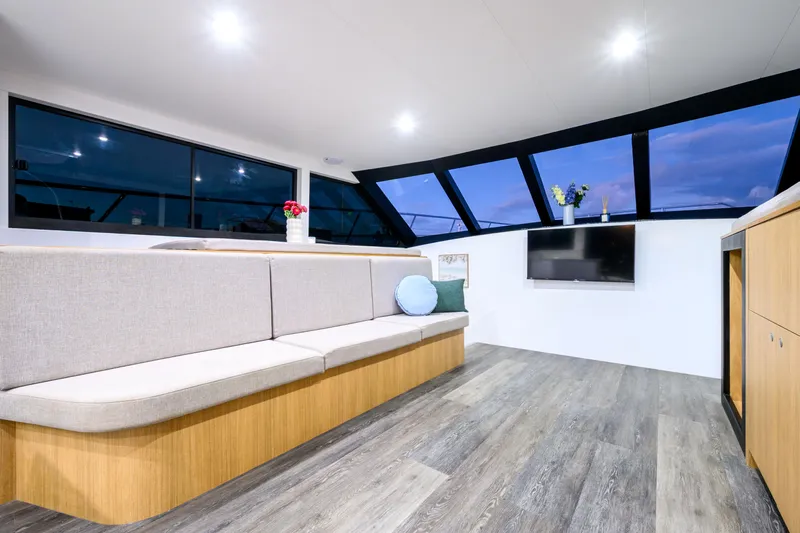 One Off Yacht Photos Pics Luxurious interior of 2019 Coral Coast 62 Power Catamaran with modern seating and large windows.