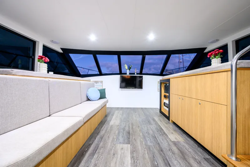 One Off Yacht Photos Pics Luxurious interior of 2019 Coral Coast 62 Power Catamaran with modern seating and panoramic windows.