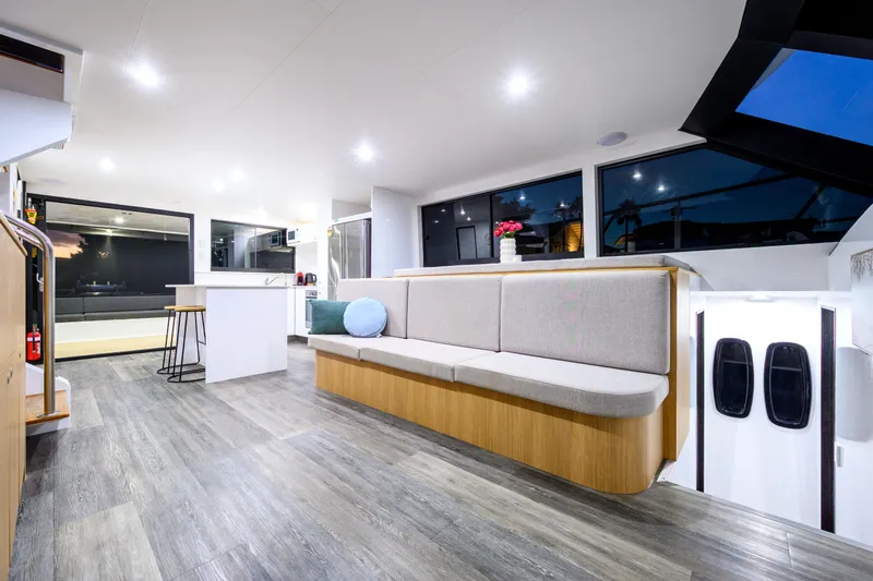 One Off Yacht Photos Pics Luxurious interior of 2019 Coral Coast 62 Power Catamaran with modern seating and kitchen area.